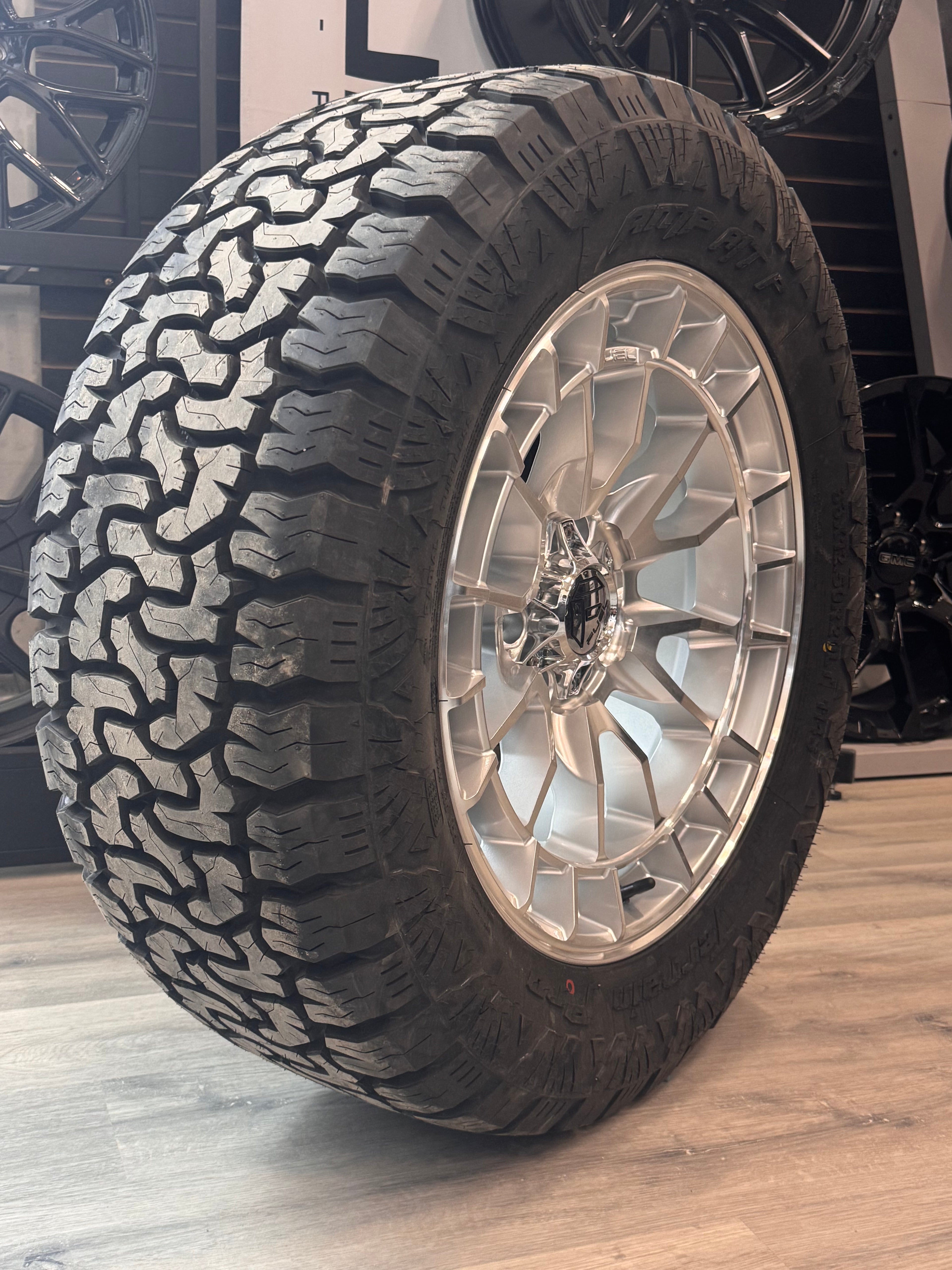( SET OF FOUR ) FUEL REVOLT 20X9 +1 6X135 87 HYPER SILVER W/ MACHINED FACE | LT 33X12.50R20 AMP TERRAIN PRO