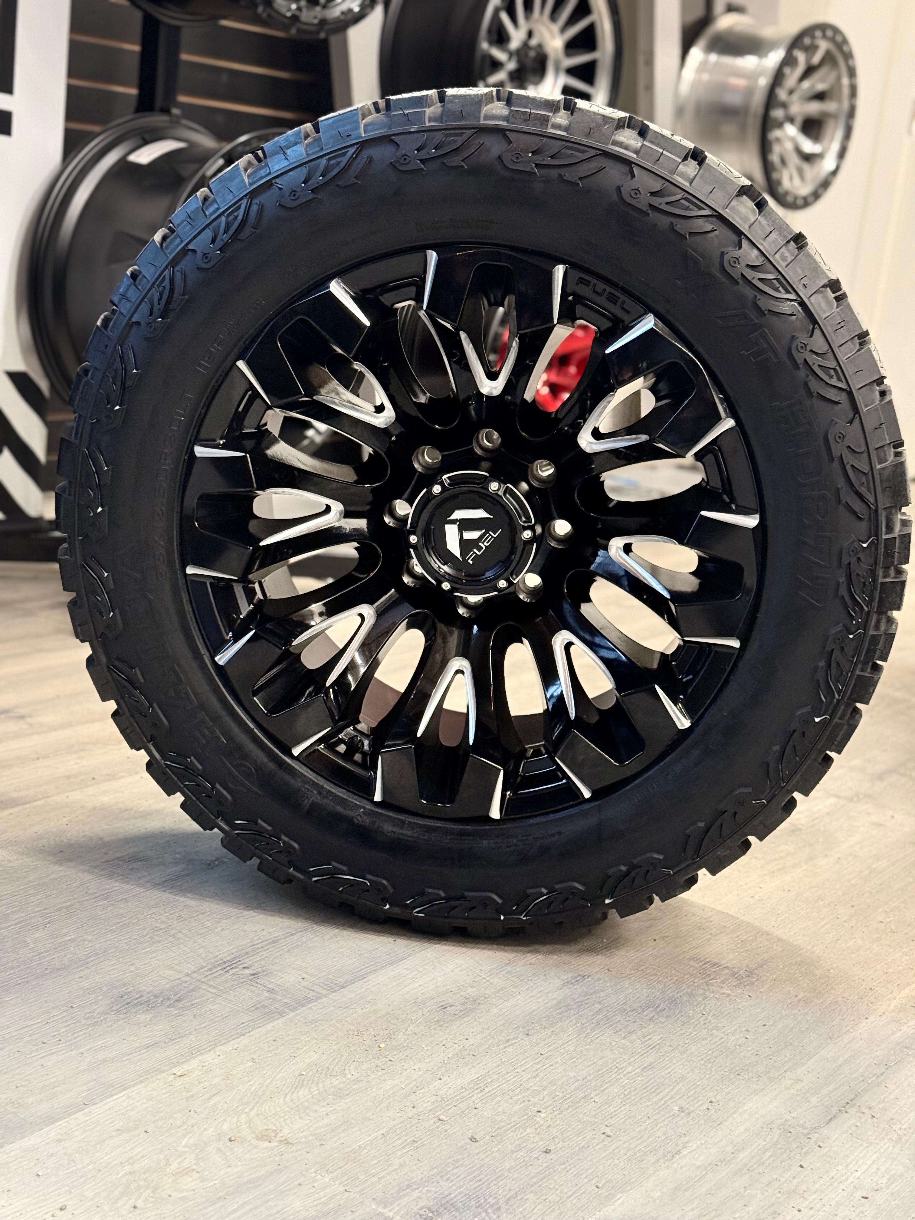 (SET OF FOUR) FUEL QUAKE 20X10 8X165.1 -18 125.1MM GLOSS BLACK MILLED | LT 33X12.50R20 HAIDA 877 X/T 3PMS (12PLY)