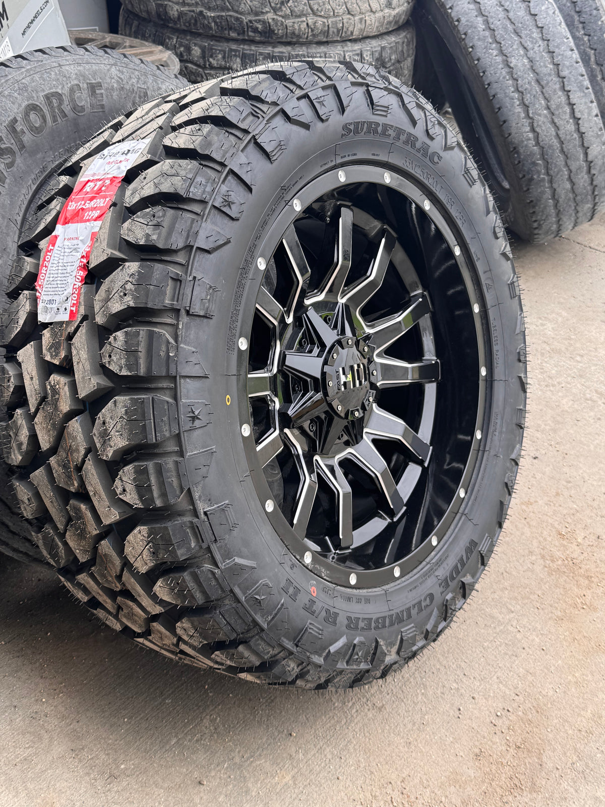 ( SET OF FOUR ) FAST HD TRAXX GLOSS BLACK MILLED 20X10 -18 6X135/6X139.7MM 95.1MM | SURETRAC R/T 2 WIDE CLIMBER LT 33X12.50R20 3PMS 12PLY