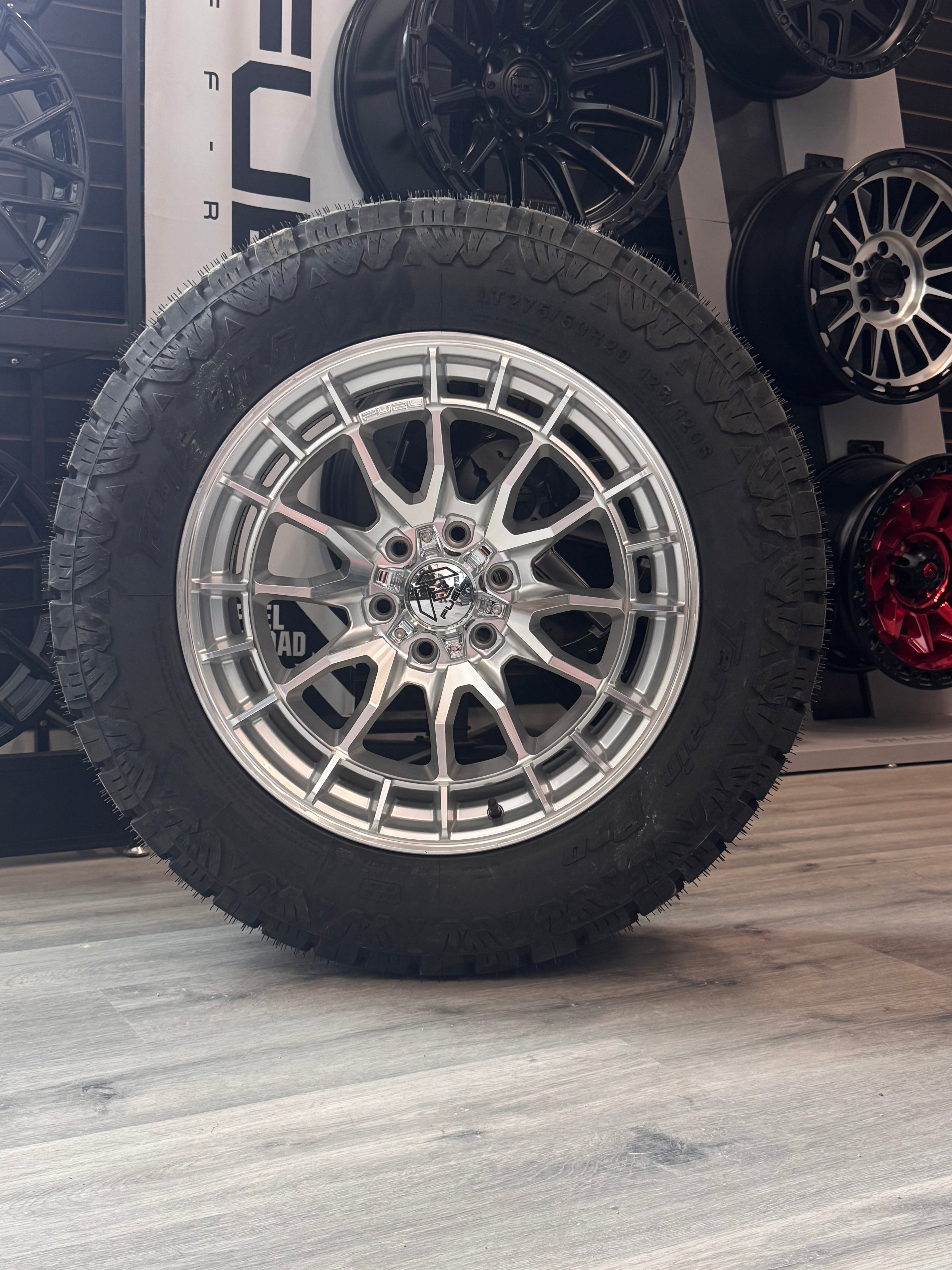 ( SET OF FOUR ) FUEL REVOLT 20X9 +1 6X135 87 HYPER SILVER W/ MACHINED FACE | LT 275/60R20 AMP TERRAIN PRO