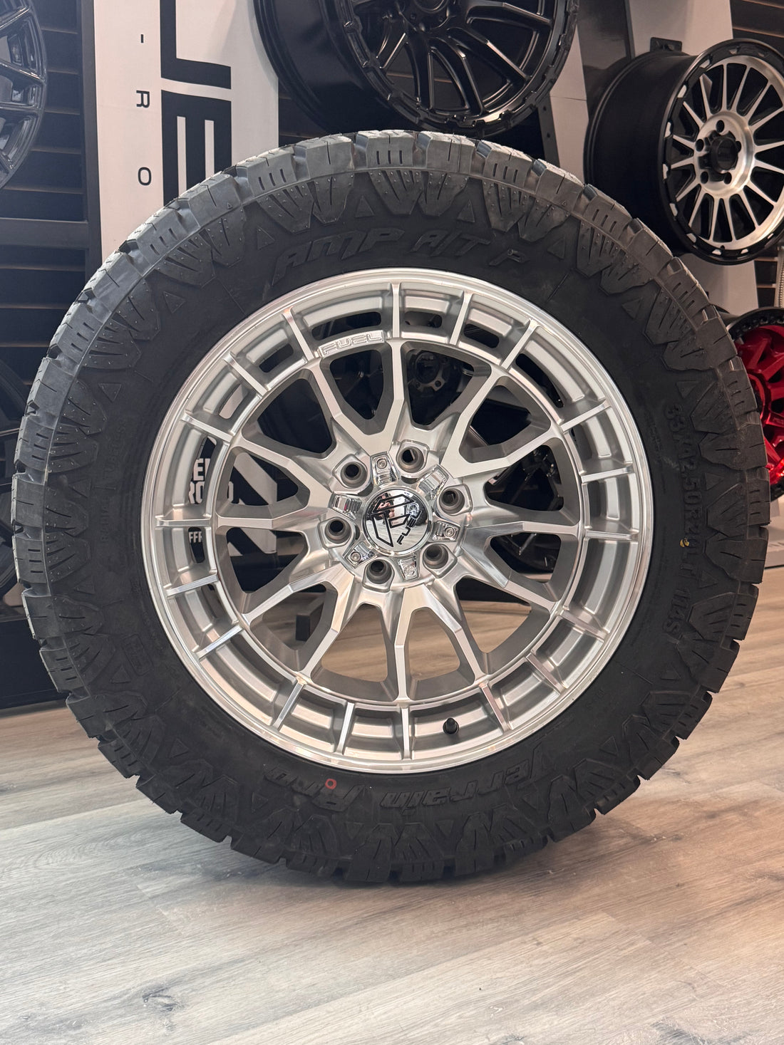 ( SET OF FOUR ) FUEL REVOLT 20X9 +1 6X135 87 HYPER SILVER W/ MACHINED FACE | LT 33X12.50R20 AMP TERRAIN PRO