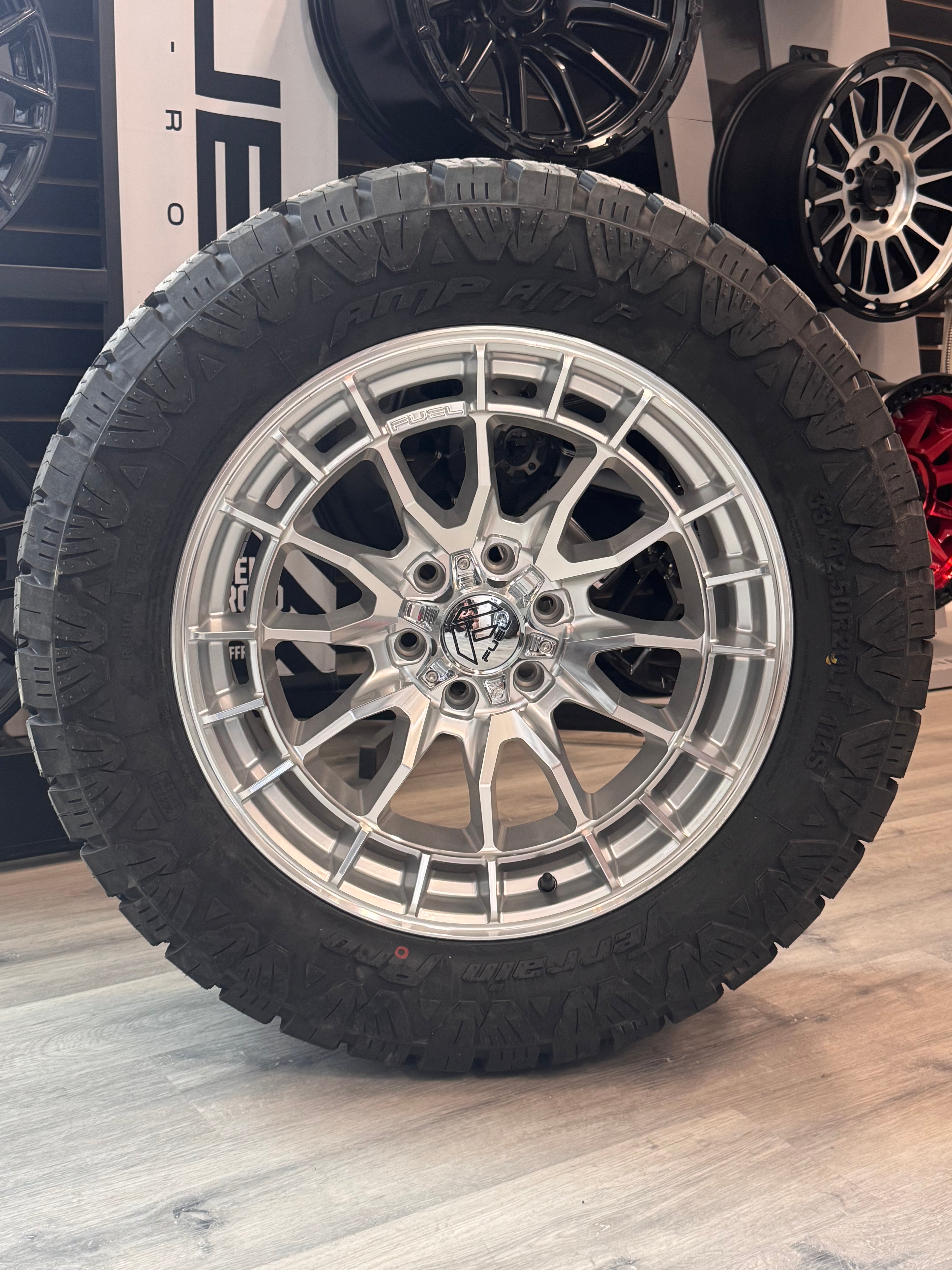 ( SET OF FOUR ) FUEL REVOLT 20X9 +1 6X135 87 HYPER SILVER W/ MACHINED FACE | LT 33X12.50R20 AMP TERRAIN PRO