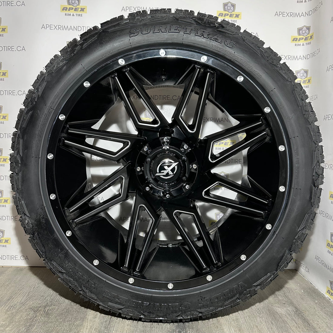 (SET OF FOUR) XF-218 GLOSS BLACK/ MILLED DOTS  | 22X12 -44 ET 6x135/6x139.7 | SURETRAC WIDE CLIMBER AWT 33X12.50R22 (10 PR)