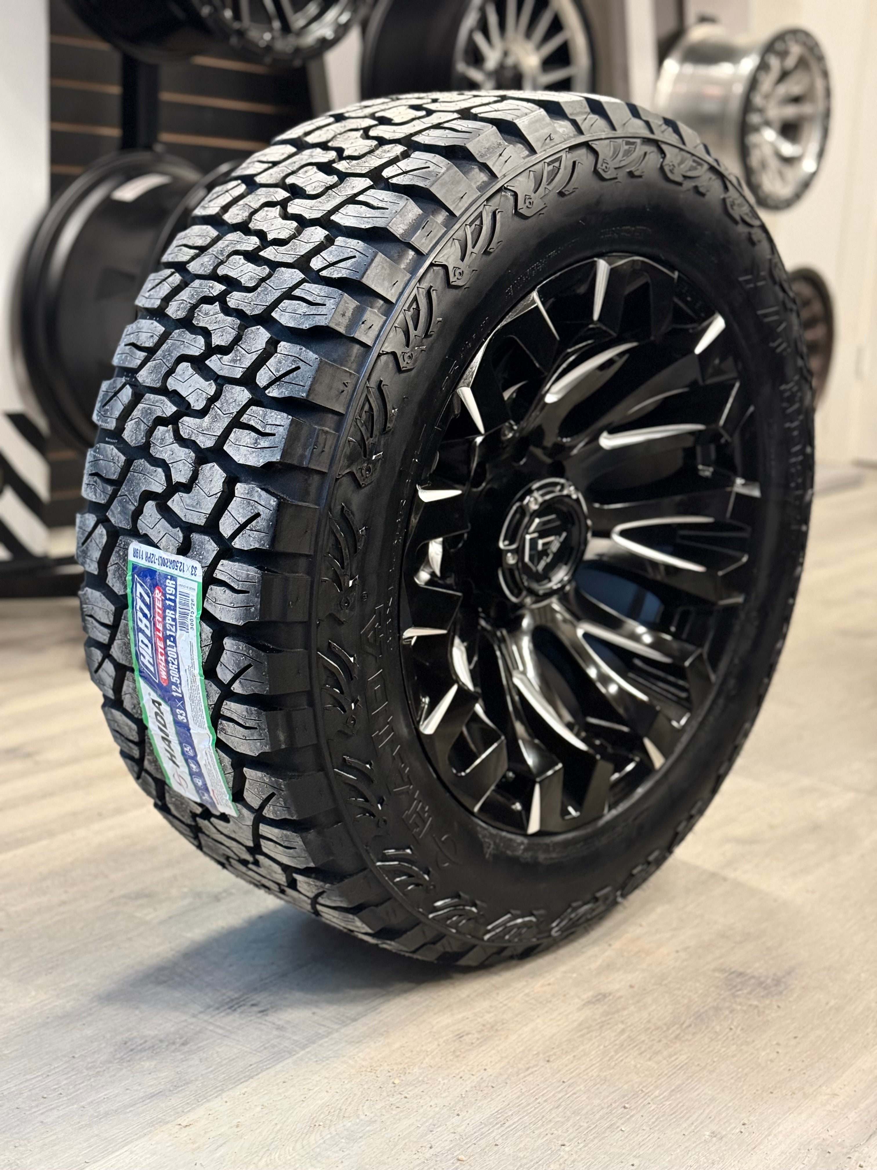 (SET OF FOUR) FUEL QUAKE 20X10 8X165.1 -18 125.1MM GLOSS BLACK MILLED | LT 33X12.50R20 HAIDA 877 X/T 3PMS (12PLY)